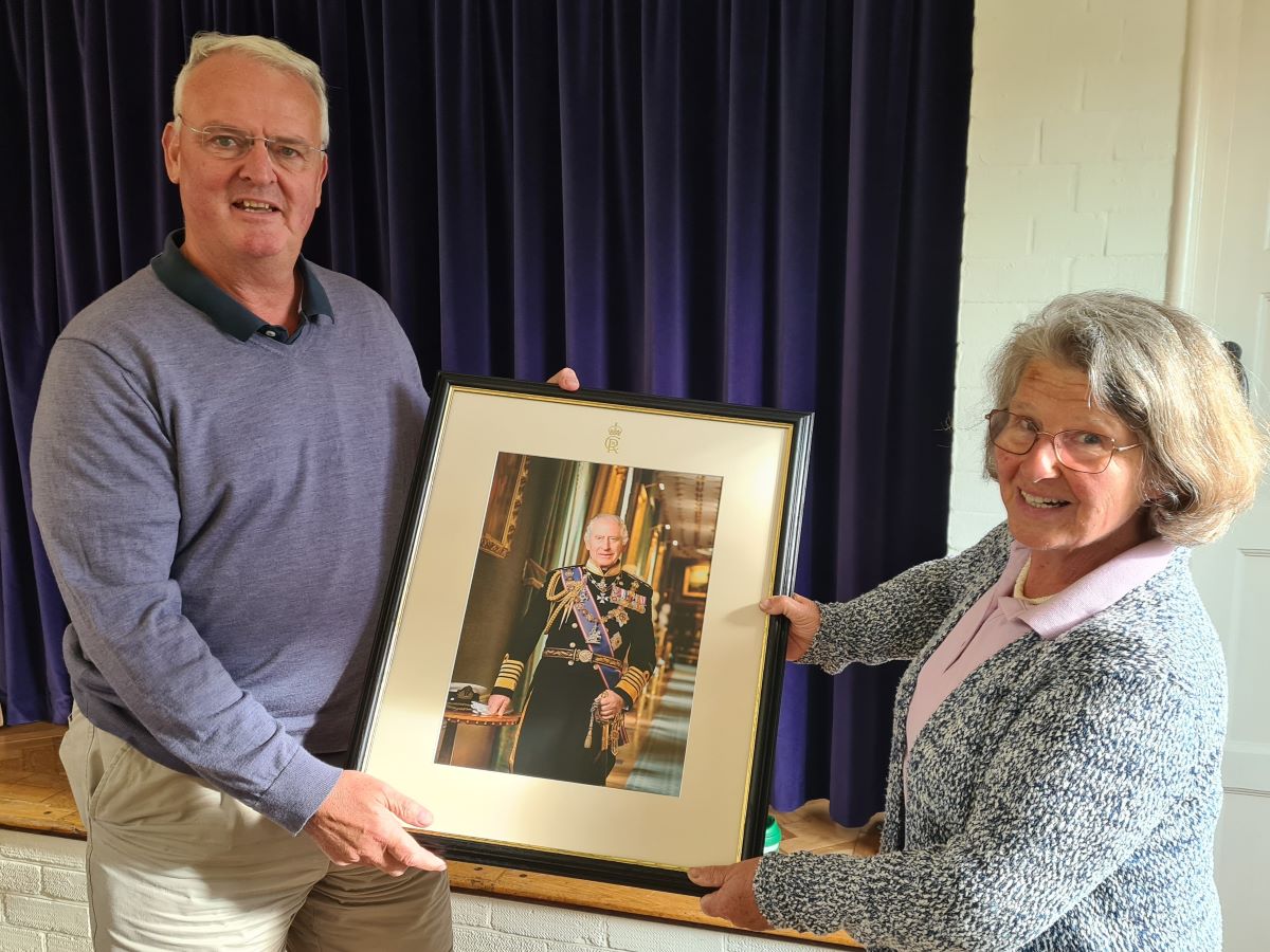 Cllr de Winton presents the King's Portrait to Brancaster Staithe Village Hall
